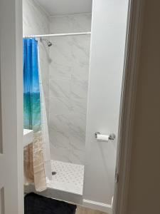 a bathroom with a shower with a glass door at One unit of a fully renovated duplex near FSU in Tallahassee