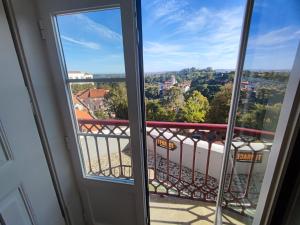 a view from the balcony of a room with a window at Sintra, T2 in historic center with Palace views, Sintra in Sintra