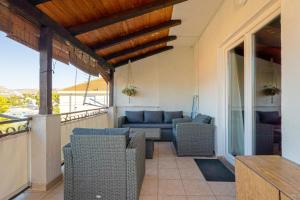 a patio with chairs and a couch on a balcony at Apartments Alen in Trogir