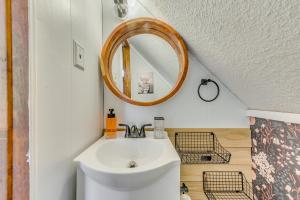 a bathroom with a sink and a mirror at Ruidoso Rental with Private Hot Tub Walk to Midtown in Ruidoso +21 photos