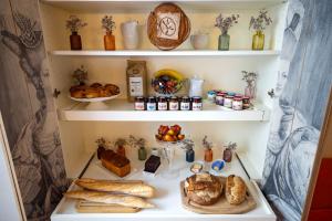 a walk in pantry with bread and other foods on shelves at Hotel Residence Foch in Paris