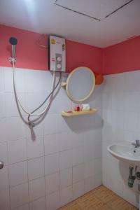 a bathroom with a mirror and a sink at Sea Shell Hut in Phi Phi Islands