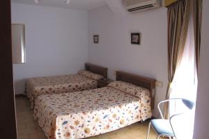 En eller flere senge i et værelse på Hostal Casa Pepe