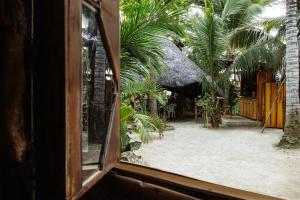 a view from a window of a patio with palm trees at Hostal Olmito Canoa in Canoa