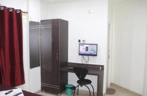 a desk with a computer and a chair in a room at Hotel Preetam Aurangabad in Aurangabad