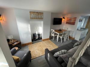 a living room with a couch and a table at Castle Wall Cottage in Conwy