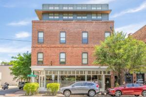 a brick building with cars parked in front of it at 2BR Loft with Terrace in Savannah
