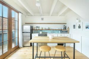 a kitchen with a wooden table and two chairs at Top Floor Loft With Terrace in Savannah