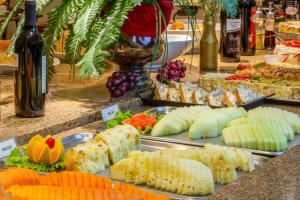 a buffet filled with lots of different types of food at Hotel Laghetto Viale in Gramado