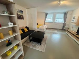 a living room with a couch and a table at Sonnenschein Appartement in Wuppertal in Wuppertal