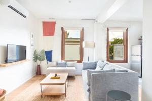 a living room with a couch and a table at Roomy Hip 2BR in Savannah in Savannah