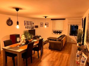 a living room with a table and a couch at Résidence du Moulin 2-C Proche de Pairi Daiza - Parking Gratuit in Boussu +13 photos