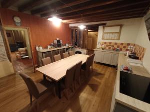 a kitchen with a large wooden table and chairs at Espace Des Fées in Saint Laurent Nouan