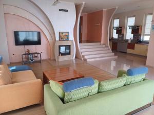 a living room with a couch and a fireplace at Guest Rooms DEVA in Burgas