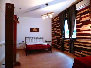 A bed or beds in a room at Camurria Sicilian B&B