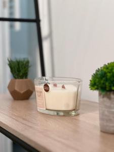 a candle in a glass container sitting on a table at Studio proche Stade de France in Saint-Denis
