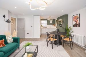 a living room with a green couch and a table at Be London - Chinatown Residences in London