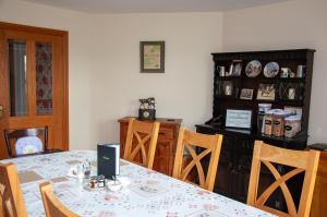 a dining room with a table and chairs at Creeghduff Lodge in Downpatrick