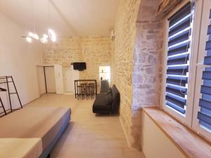 a living room with a couch and a window at Maison Divino in Trani