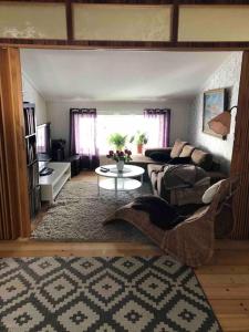 ein Wohnzimmer mit einem Sofa und einem Tisch in der Unterkunft Lantligt boende in Luleå