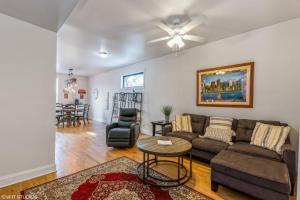 a living room with a couch and a table at Belmont & Racine - Walk to Wrigley & Southport Corridor & Belmont L Train Station! in Chicago