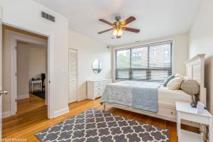 a bedroom with a bed and a ceiling fan at Belmont & Racine - Walk to Wrigley & Southport Corridor & Belmont L Train Station! in Chicago