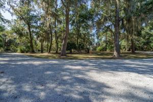 a large parking lot with trees in a park at Edisto Hidden Oasis in Edisto Island