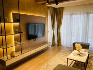 a living room with a television on a wall at Villa Selzo lux in Pale