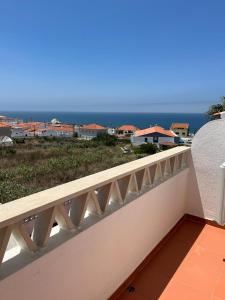 a white balcony with a view of the ocean at Villa Bela Vista near a surf spot in Ericeira