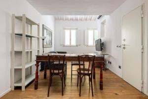 a dining room with a wooden table and chairs at UNYCA - Residenza San Lorenzo in Florence