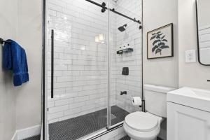 a bathroom with a shower and a toilet at Newly Renovated 2BR Haven Walk to Columbia Uni in New York +20 photos