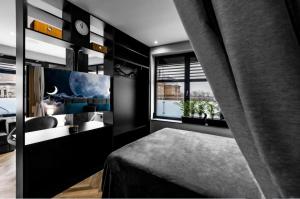a bedroom with a bed and a sink and a window at Moon Apartment in Bielsko-Biala