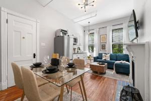 a dining room and living room with a table and chairs at Newly Renovated 3BR Oasis Walk to Columbia Uni in New York