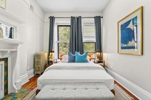 a bedroom with a large bed with blue pillows at 3BR Retreat Walkable to Columbia University in New York