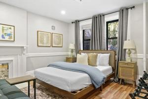 a bedroom with a bed and a fireplace at Newly Renovated 2BR w Rare Private Backyard and BBQ in New York