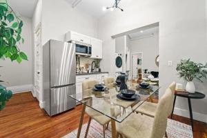a kitchen and living room with a glass table and chairs at 3BR Retreat Walkable to Columbia University in New York