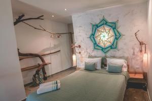 a bedroom with two beds and a large wall at Namaste Beach Club & Hotel in Tierra Bomba