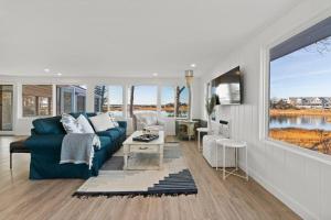 uma sala de estar com um sofá azul e uma grande janela em Waterfront Newly Renovated w Amazing Views em Oak Bluffs