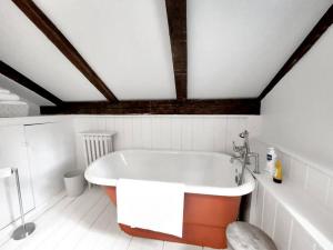 a bath tub in a bathroom with a ceiling at Historic Estate - 5 min to Mohawk Mt Ski Resort 