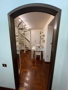 a hallway with a room with a table and a staircase at CastelS'AntangeloDreamSuite in Rome