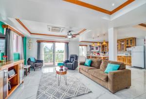 a living room with a couch and a kitchen at Miramar Suites in Placencia Village