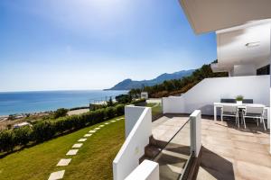 a view of the ocean from the balcony of a house at "Thea" Luxury Apartments with great View in Plakias