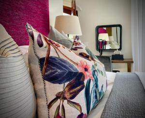 a bedroom with a bed with a pillow on it at Calais Guest House in Franschhoek