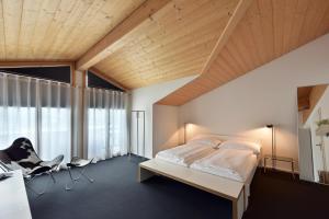 a bedroom with a bed and a large window at Luna Elk Home in Lenk
