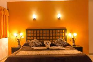 a bedroom with two swans laying on a bed at Hotel Rosalia in Valladolid