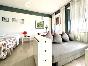 a white bedroom with a bed and a window at Fratelli Bandiera in Latina