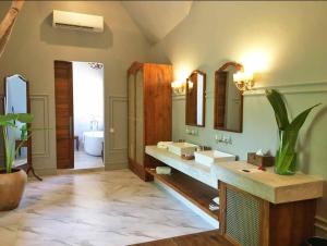 a large bathroom with two sinks and a tub at Upendo Beach Boutique Hotel Zanzibar in Michamvi