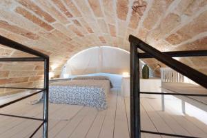 a bedroom with a bed in a brick wall at Apartments in Spongano/Apulien 20947 in Spongano
