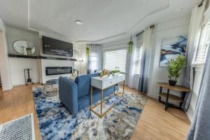 a living room with a blue couch and a table at Spacious 5 BR Home with 3 Bath, 5 mins from SFO in San Bruno