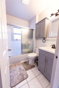 a bathroom with a toilet and a sink and a shower at Spacious 5 BR Home with 3 Bath, 5 mins from SFO in San Bruno